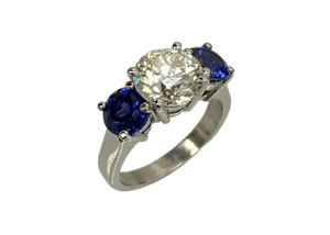 three stone diamond ring with sapphire side stones
